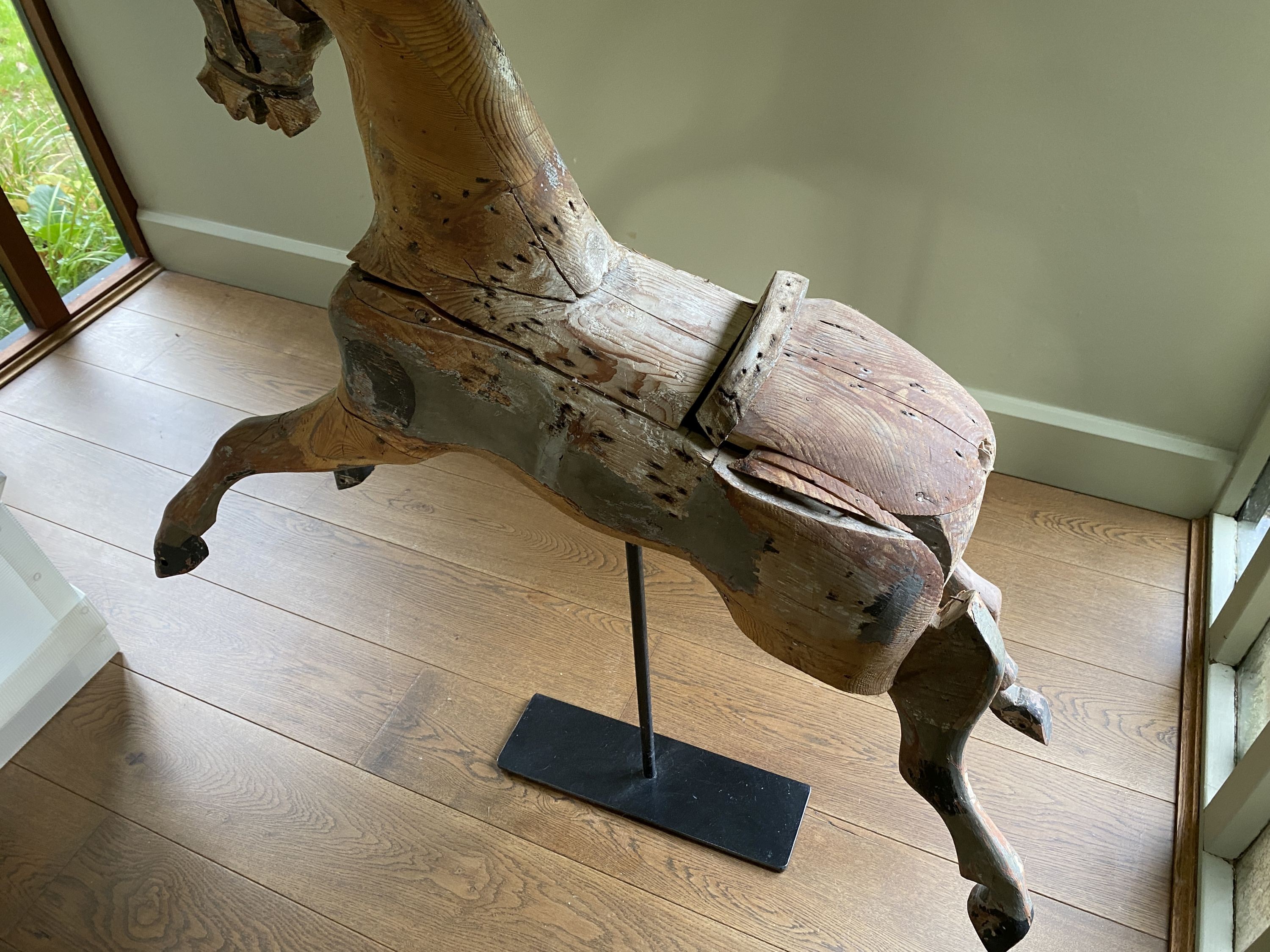 A Victorian painted pine rocking horse, now on wrought iron stand, length 96cm height including stand 108cm